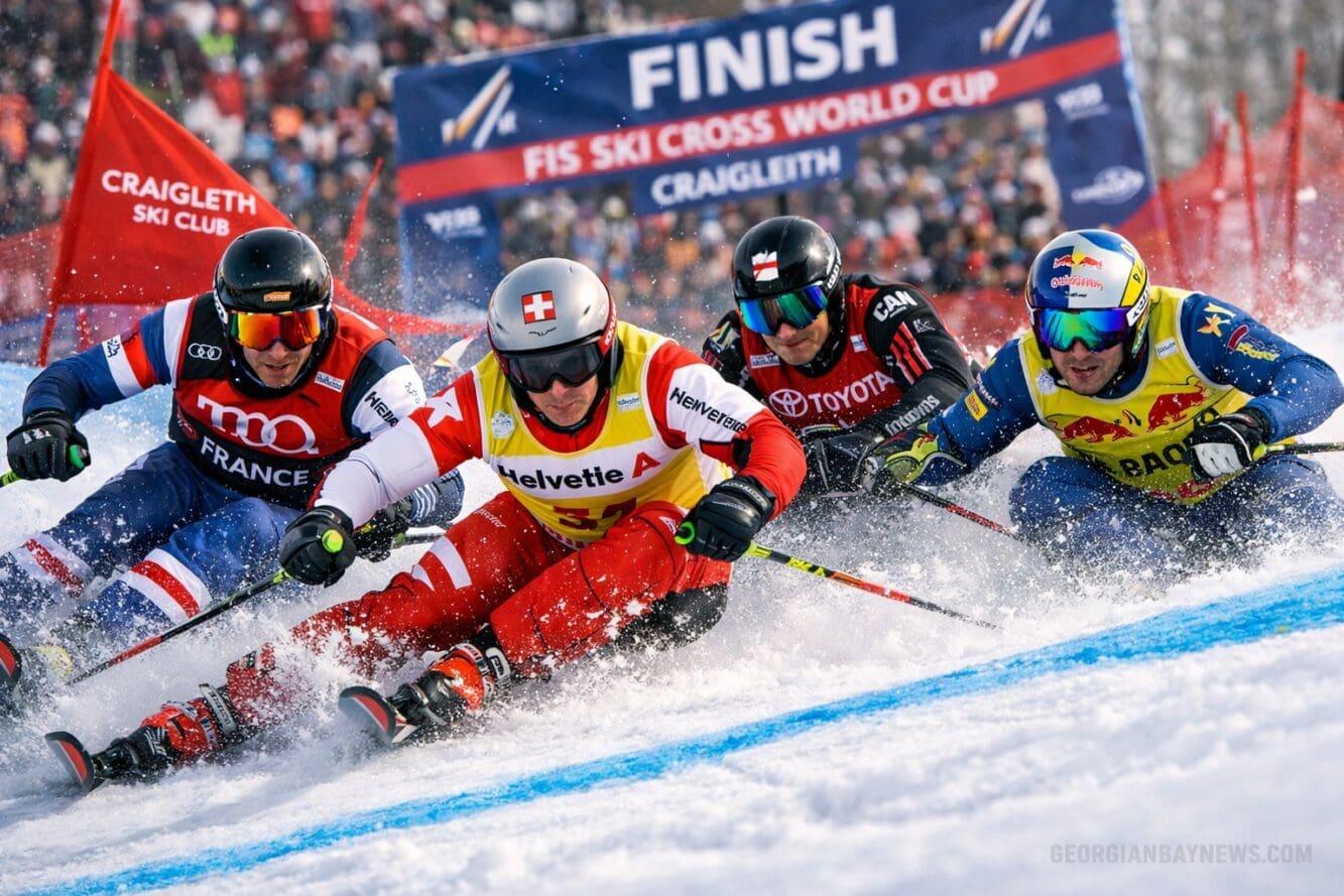 Professional editorial action image centered on the elite competition side of the FIS Ski Cross World Cup. Use a low-angle