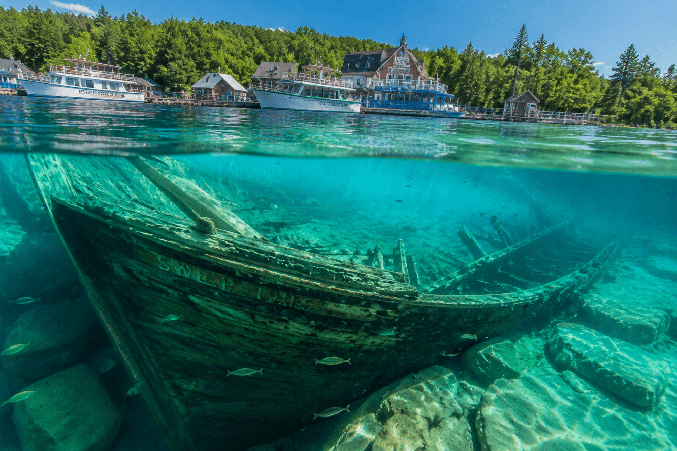 Detailed () editorial image showing an underwater split-shot perspective at Fathom Five National Marine Park: above